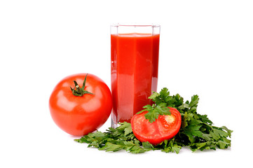 Full glass of fresh tomato juice and tomatoes with parsley