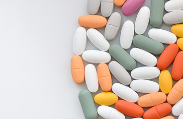 Stack of different pills isolated on white background