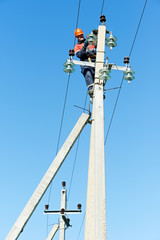 power electrician lineman at work on pole