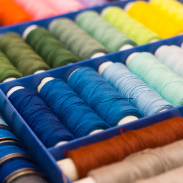 colorful sewing thread on white background