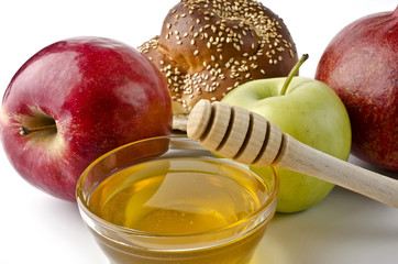 Round challah, apples and a bowl of honey