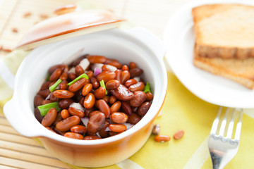 brown beans with onion in a ceramic pot