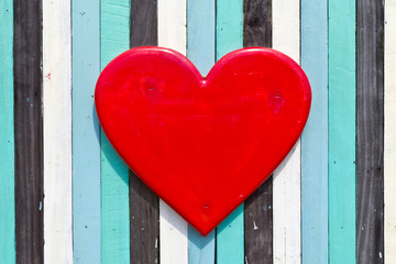 Red heart on the wooden wall