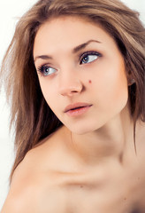 Fototapeta premium Attractive beautiful young girl on a white background