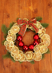 christmas wreath of dried lemons with fir tree and balls,
