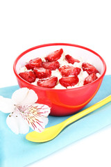 Cottage cheese in red bowl with sliced strawberries isolated