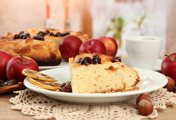 slice of tasty homemade pie with jam and apples and cup of