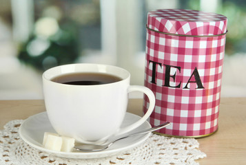 Jar and cup of tea isolated on white