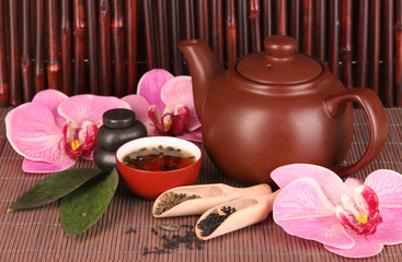 Chinese tea ceremony on bamboo table on bamboo background