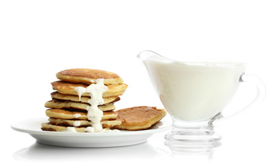 Sweet pancakes on plate with condensed milk isolated on white