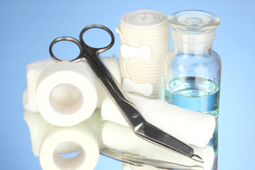 First aid kit for bandaging on blue background