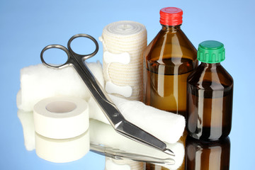 First aid kit for bandaging on blue background