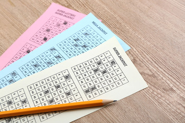 Lottery tickets and pencil, on wooden background