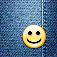Happy smiley face badge on blue denim