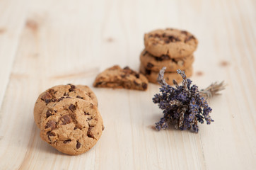 Fototapeta na wymiar Chocolate chips cookies on a wooden table with lavender bunch