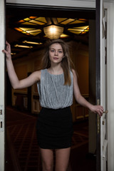 A young woman enters the door