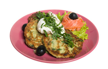 Roasted cutlets of potato with salmon on a plate