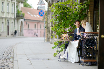 Bride and groom drinking wine