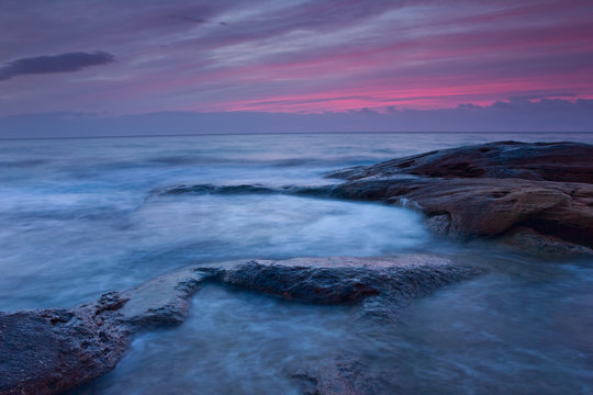 Sunrise over the rocky seashore © niki spasov