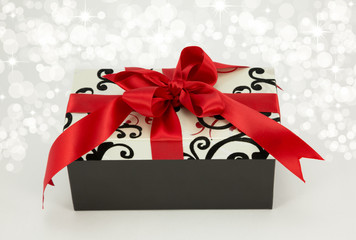 Gift wrapped with red ribbon.