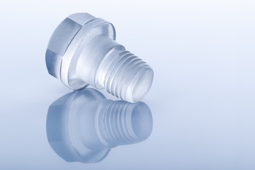Unusual Bolt made of transparent plastic on blue background