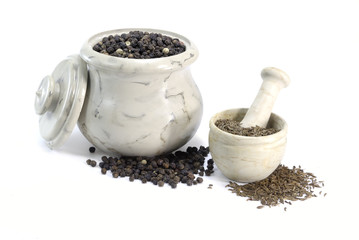 Pepper and Cumin in little bowls on on white background