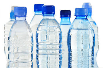 Naklejka premium Plastic bottles of mineral water isolated on white