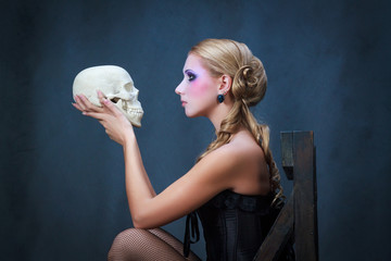 Woman with a skull, studio shot