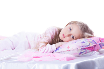 Little girl lying on bed
