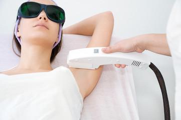 Young woman receiving epilation laser treatment
