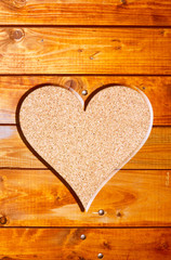 heart in a tree trunk on cork background