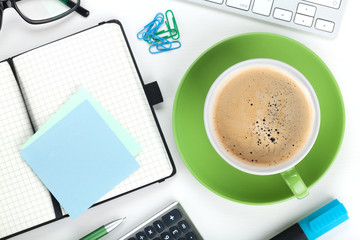 Green coffee cup and office supplies