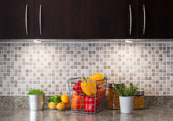 Vegetables, fruits and herbs in a kitchen with cozy lighting
