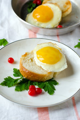 Crostini with a fried egg . Breakfast.