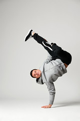 cool dancer posing over grey background