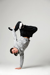 hip-hop dancer over grey background