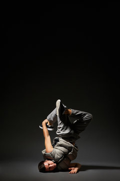 hip-hop dancer posing over dark