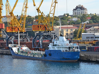 Bulk cargo ship under port crane bridge, Odessa, Ukraine