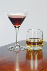 Red wine in a glass for wine and whiskey in a glass