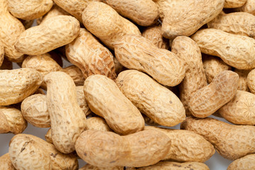 .Dried peanuts in closeup on the white background