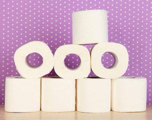 Rolls of toilet paper on purple with dots background