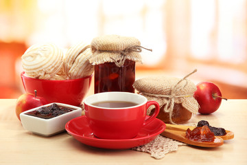 light breakfast with tea and homemade jam, on wooden table
