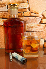 Bottle and Glass of whiskey and cigar on brick wall background