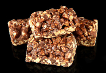 Chocolate sweets with nuts, isolated on black
