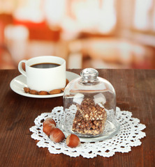 Chocolate sweets under glass cover and hot drink