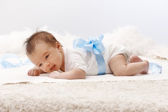 Newborn baby lying on front