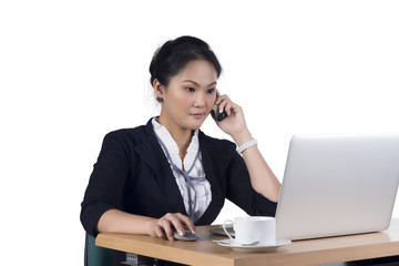 Portrait of business woman speaking on mobile phone while using