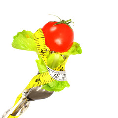 Measuring tape and a fork with tomato