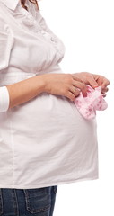Obraz na płótnie Canvas Pregnant woman keeping pink baby-shoes.
