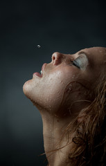 Portrait of a girl's face which water flows